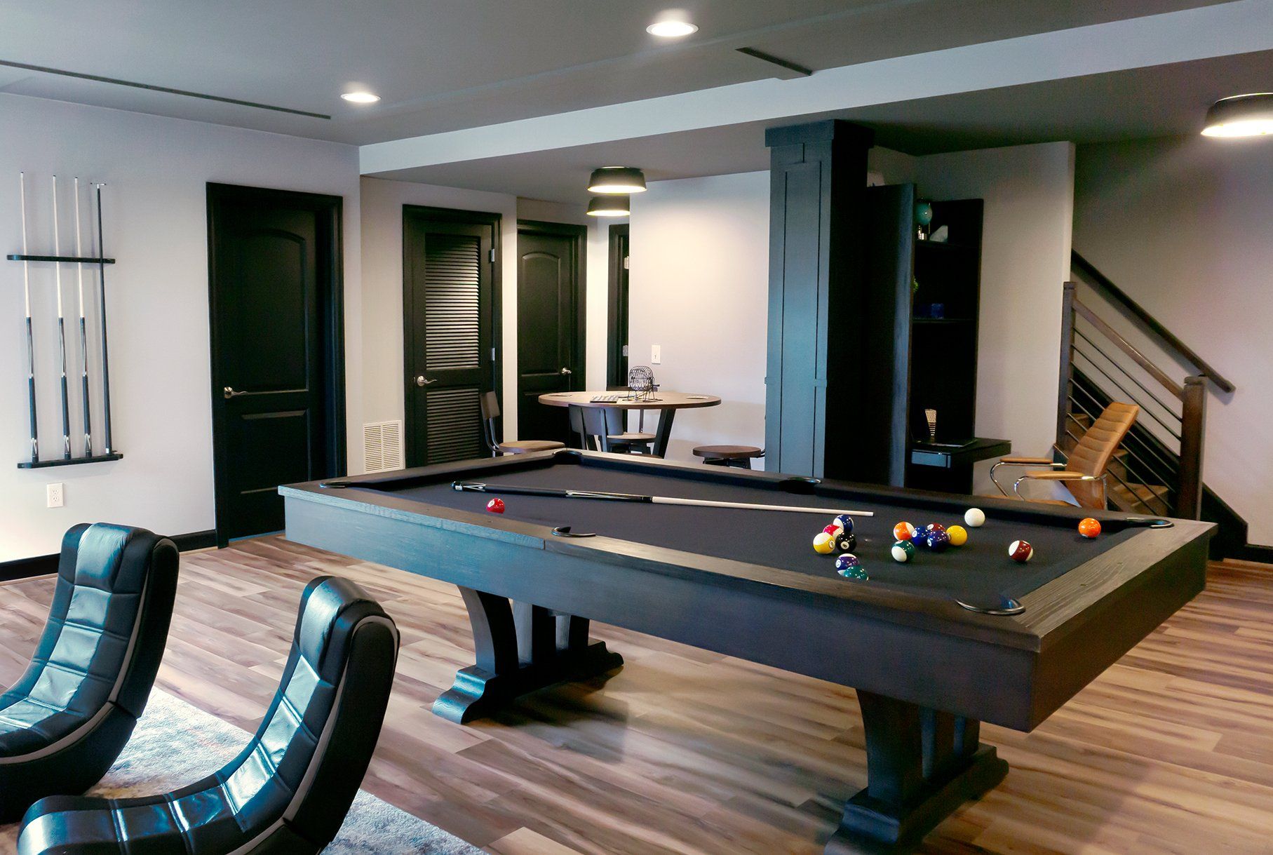 There is a pool table in the middle of the room.