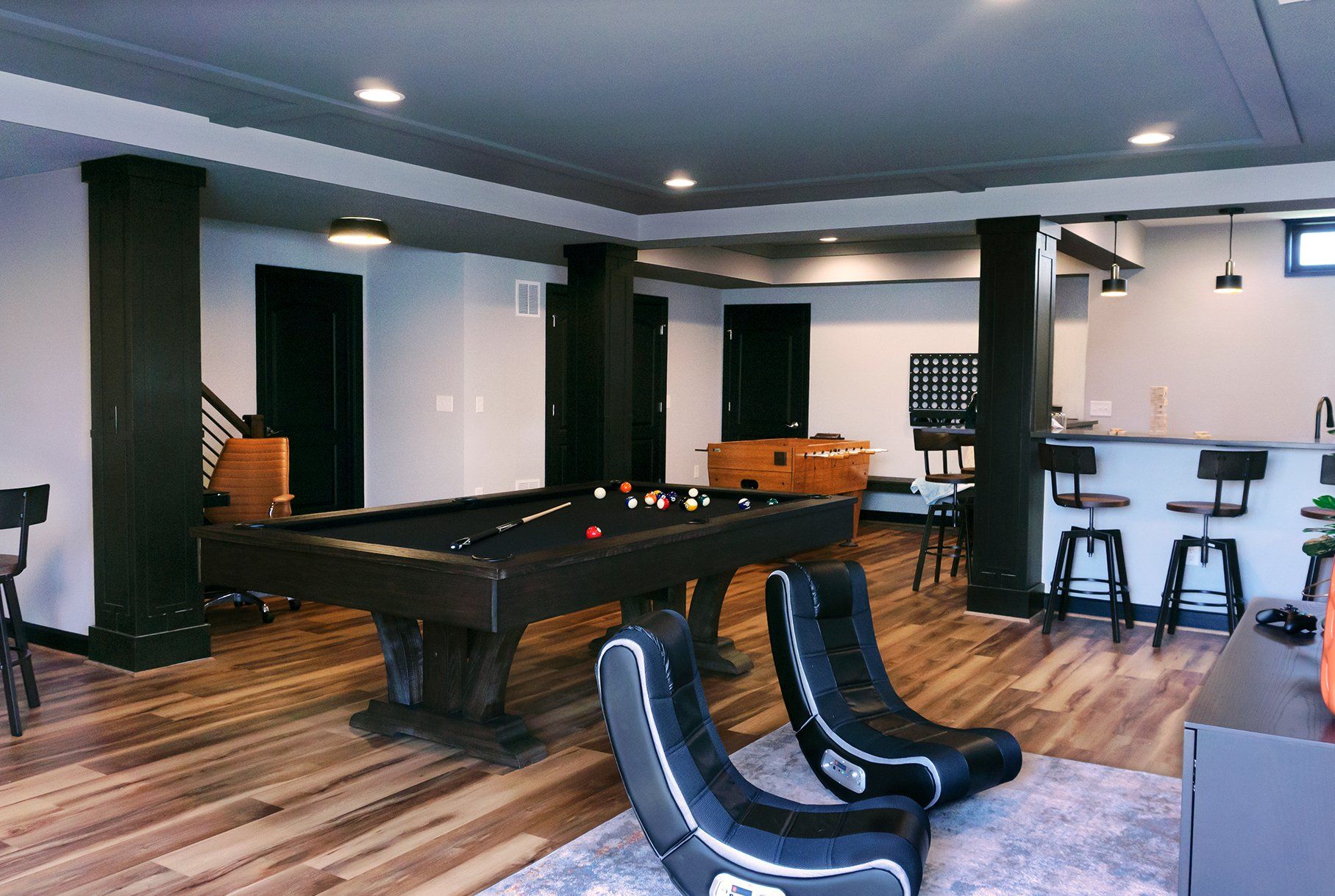 There is a pool table in the middle of the room.