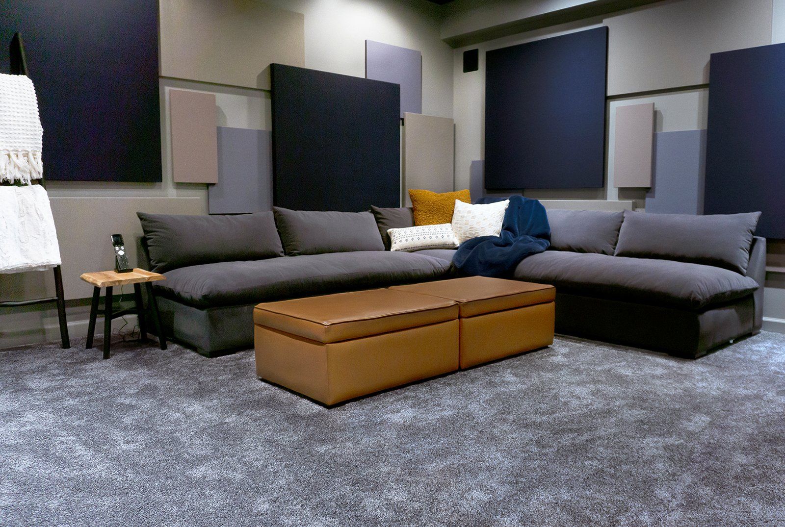 A living room with a large sectional couch and a coffee table.