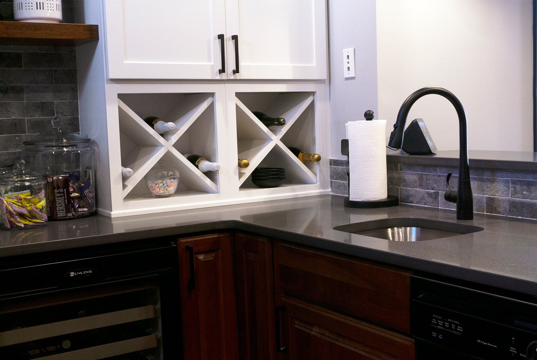 A kitchen with a wine rack and a sink