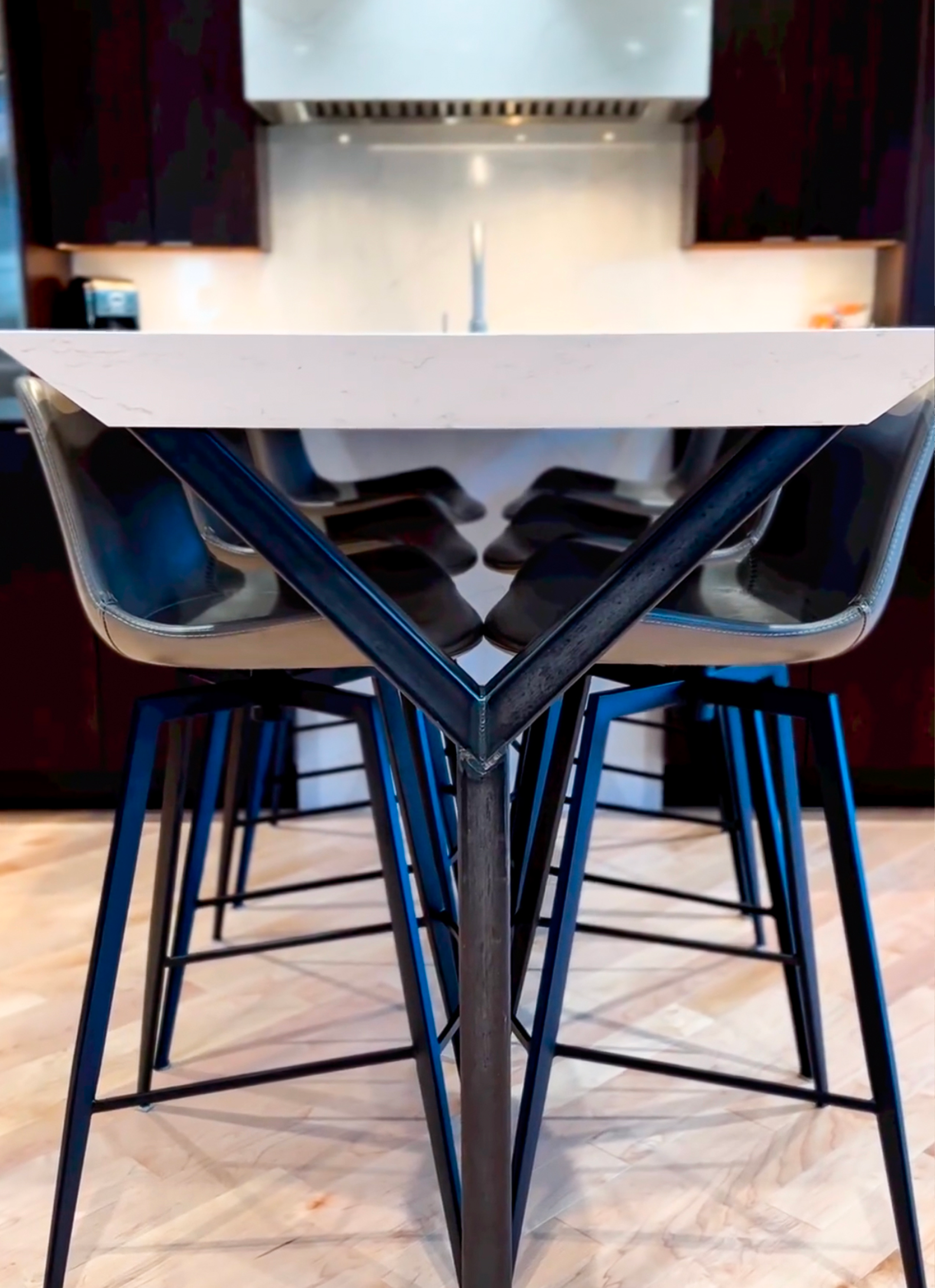 A kitchen with a white table and blue chairs