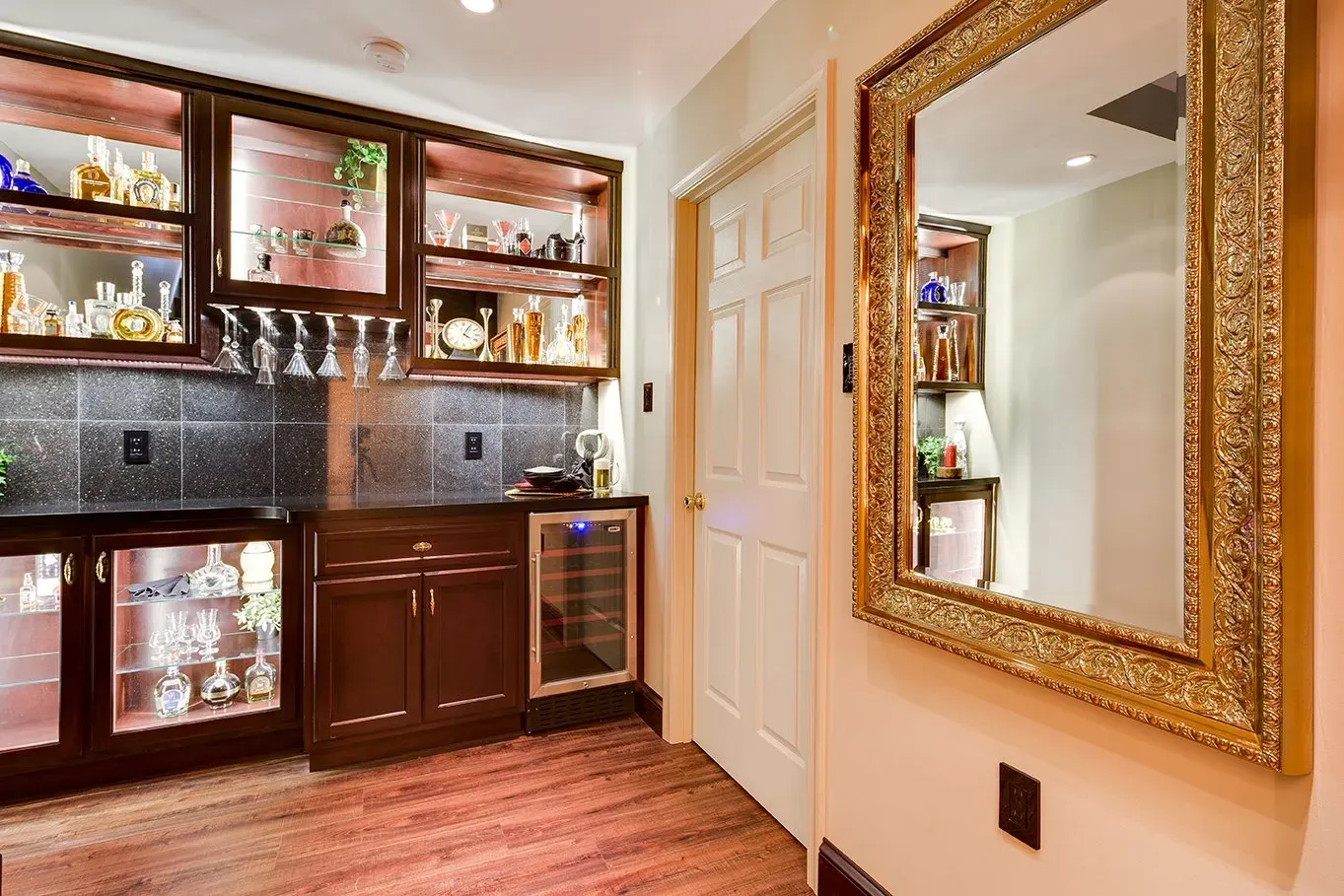 A hallway with a bar and a mirror on the wall.