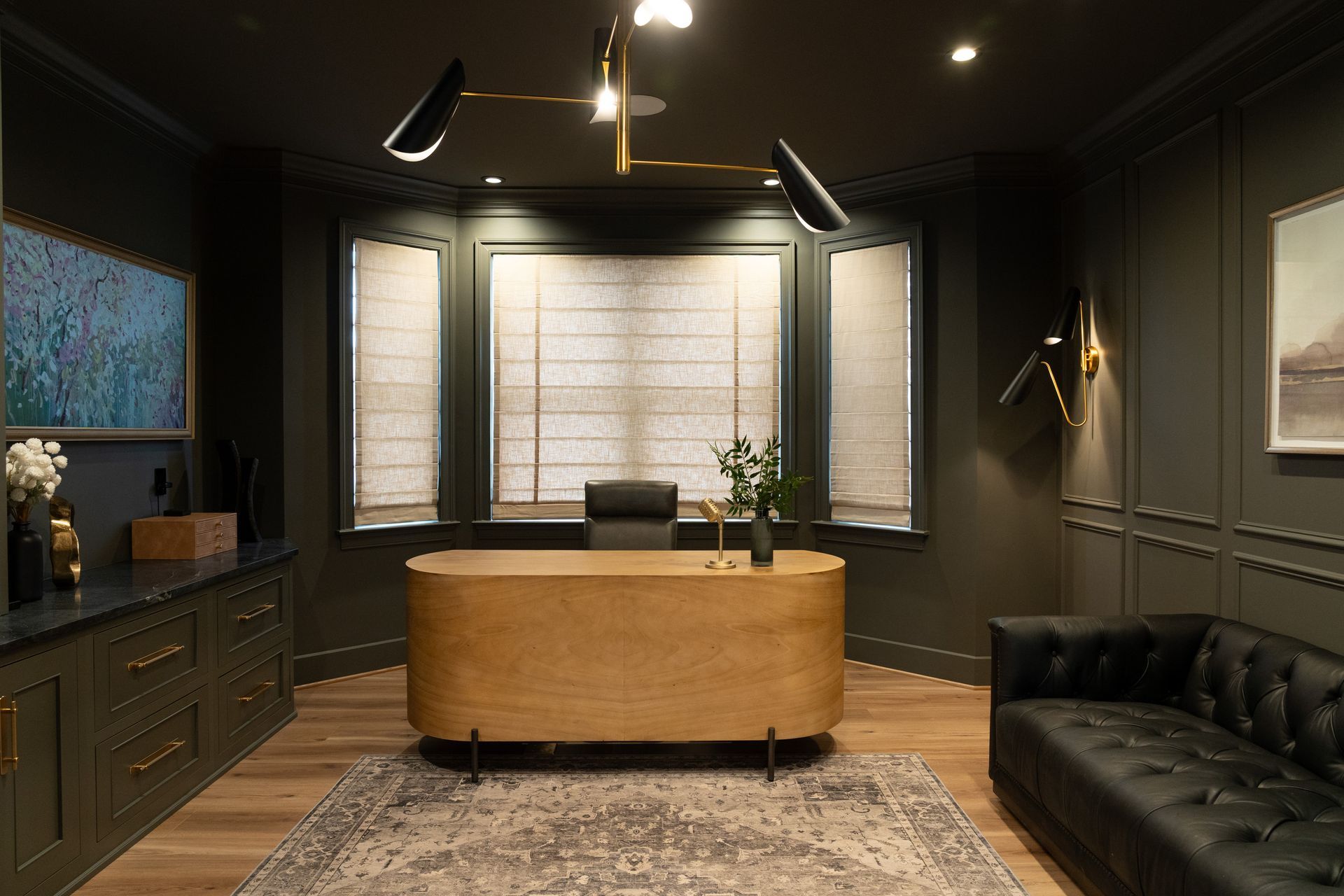 A home office with a desk and a couch.