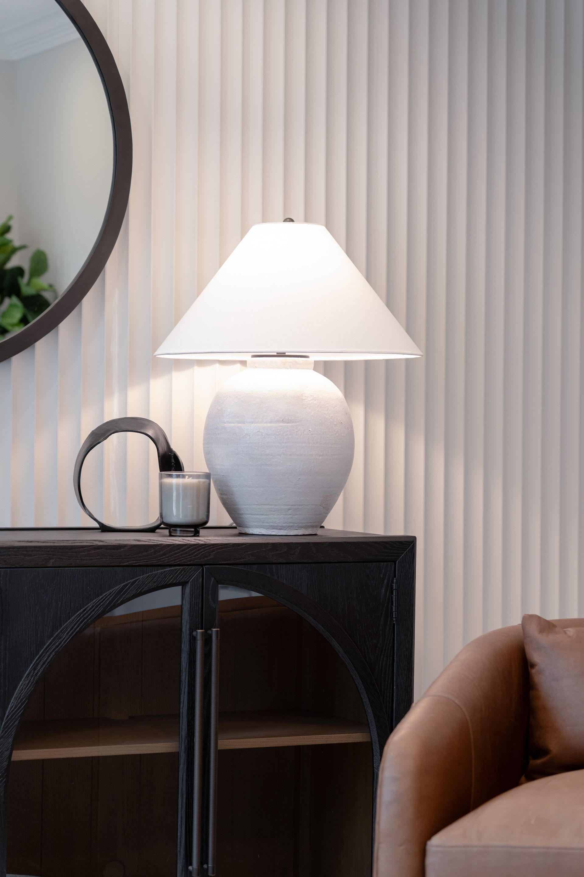 A lamp is sitting on top of a table in a living room.