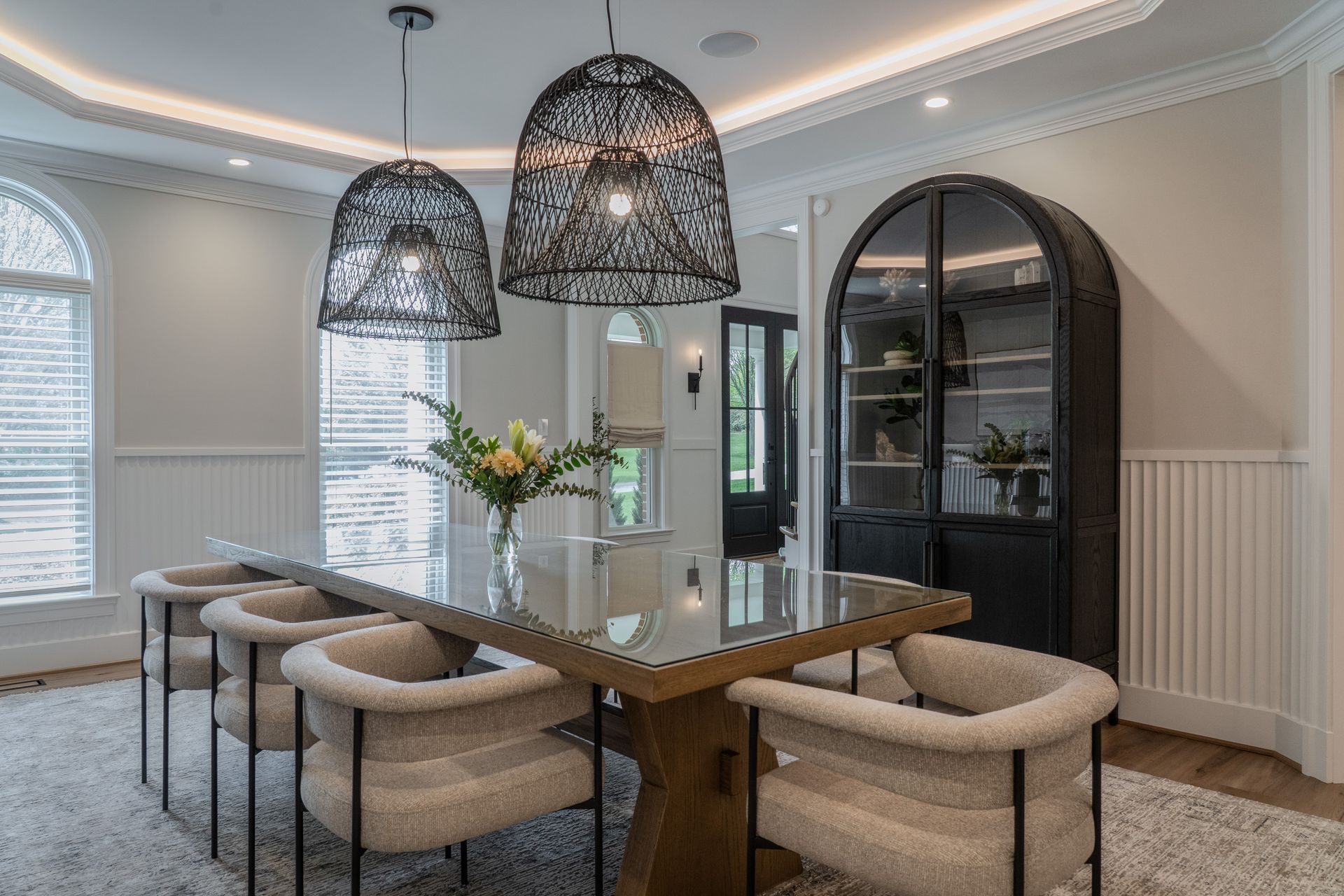 A dining room with a long table and chairs.