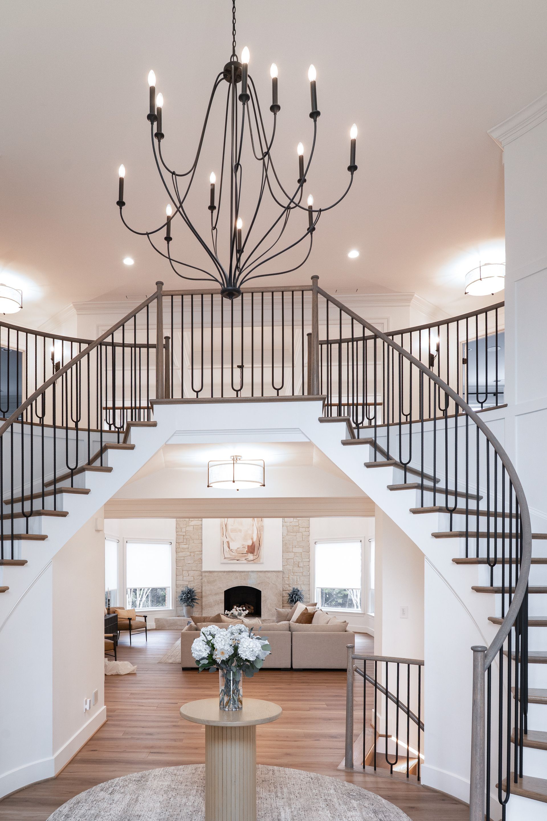There is a chandelier hanging from the ceiling in the middle of the room.
