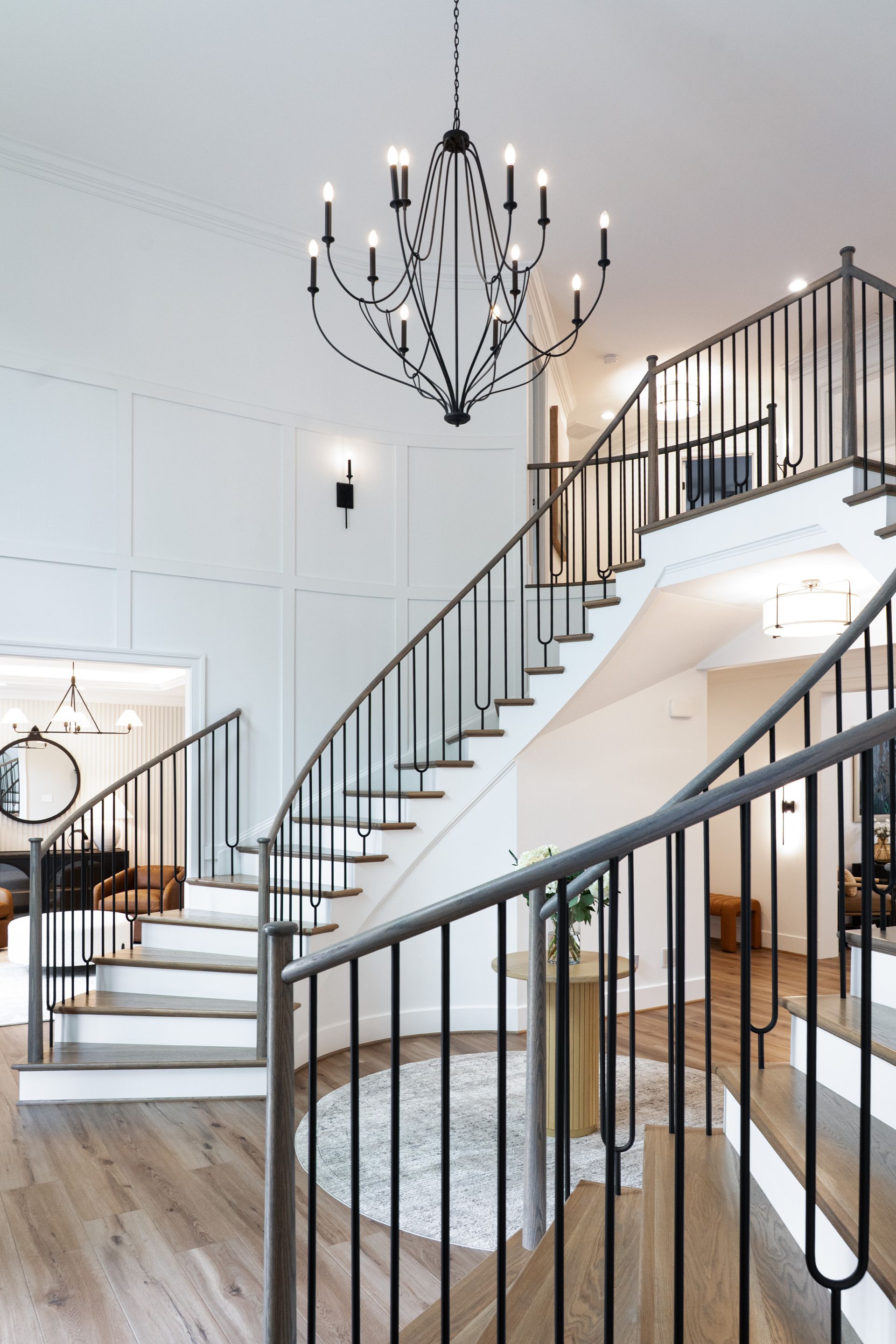 A large staircase with a chandelier hanging from the ceiling