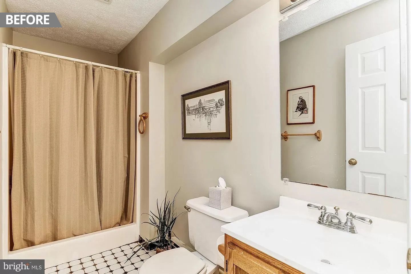 A bathroom with a toilet , sink , shower and mirror.