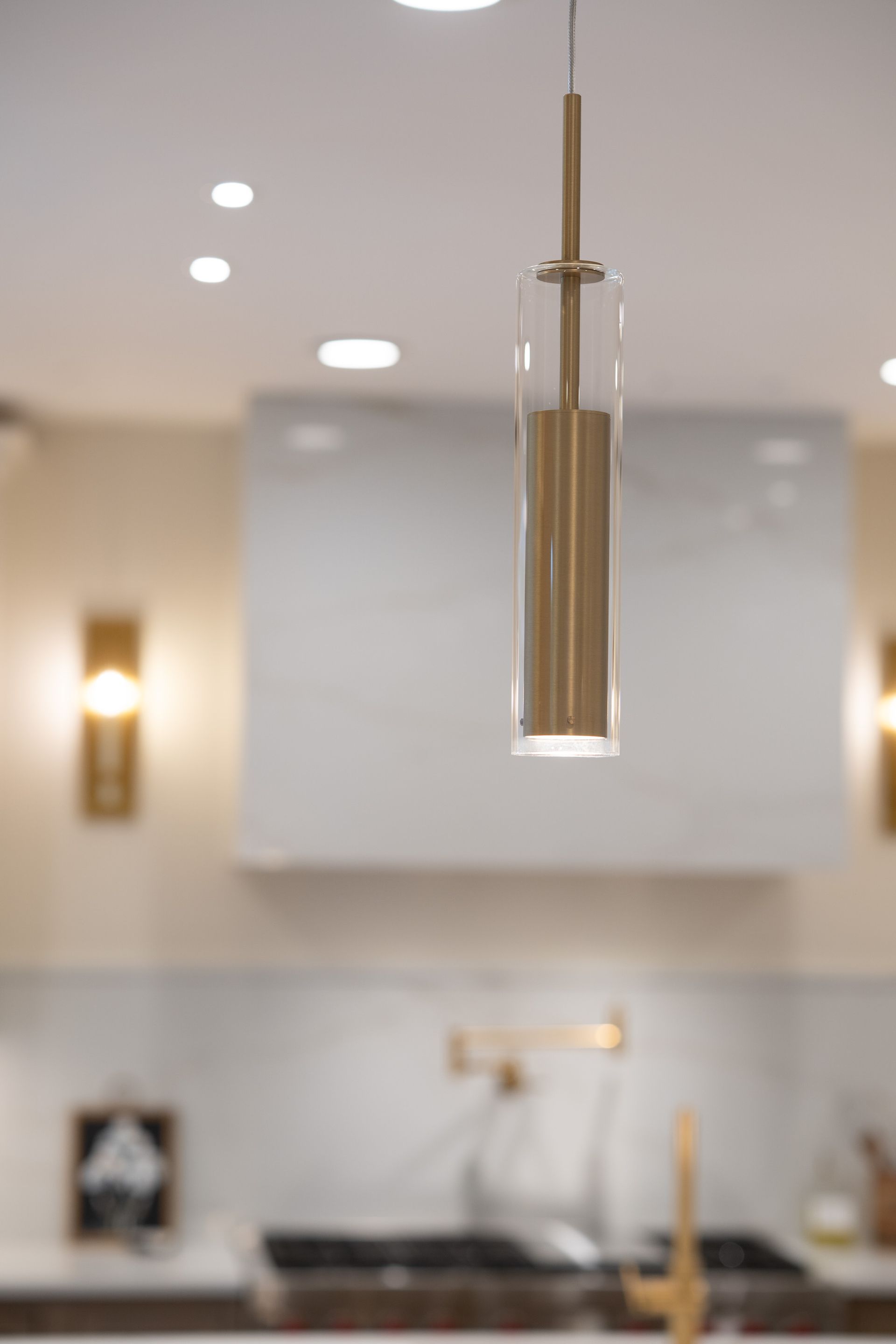 A pendant light is hanging from the ceiling in a kitchen.
