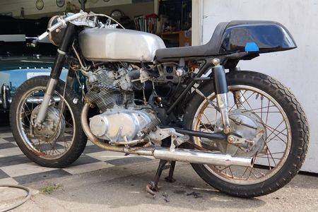 a motorcycle is parked in front of a garage door