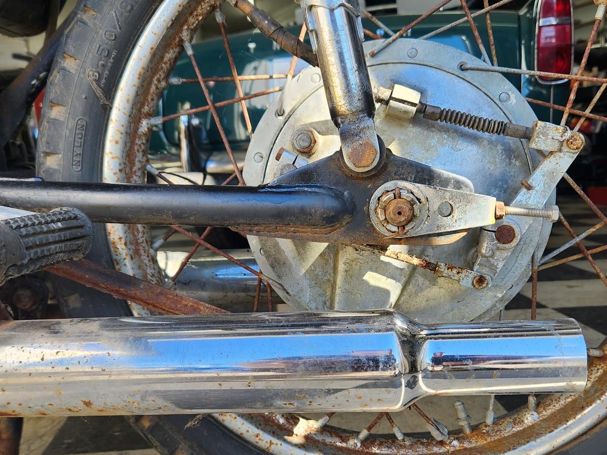 A close up of the rear wheel of a motorcycle.