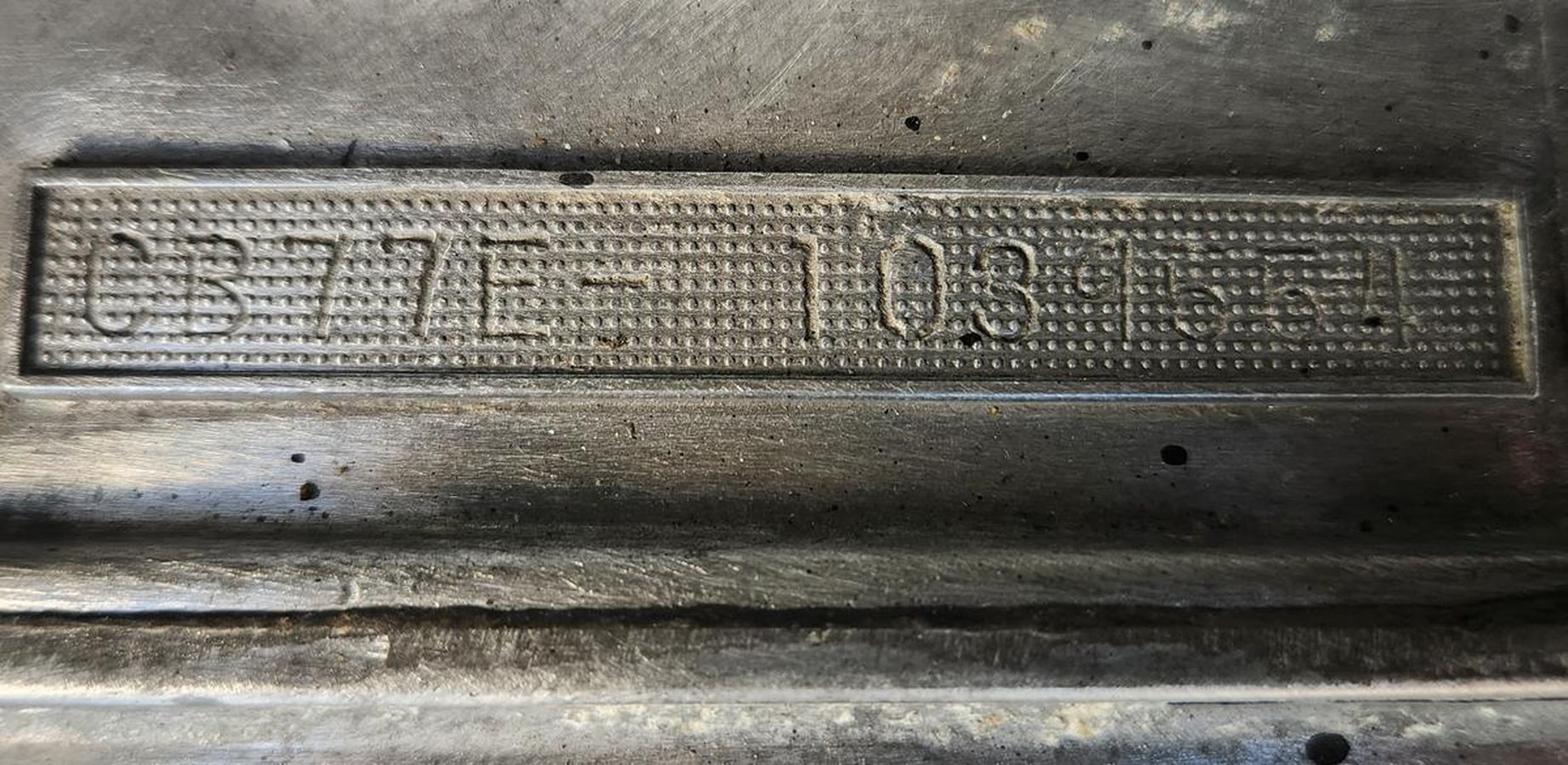 A close up of a metal item with a number on it.