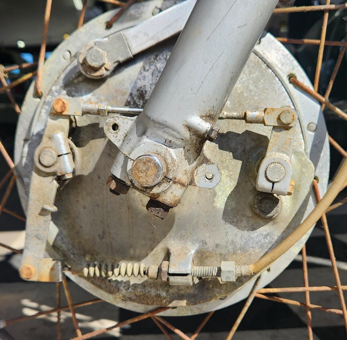 A close up of a motorcycle wheel with rust on it