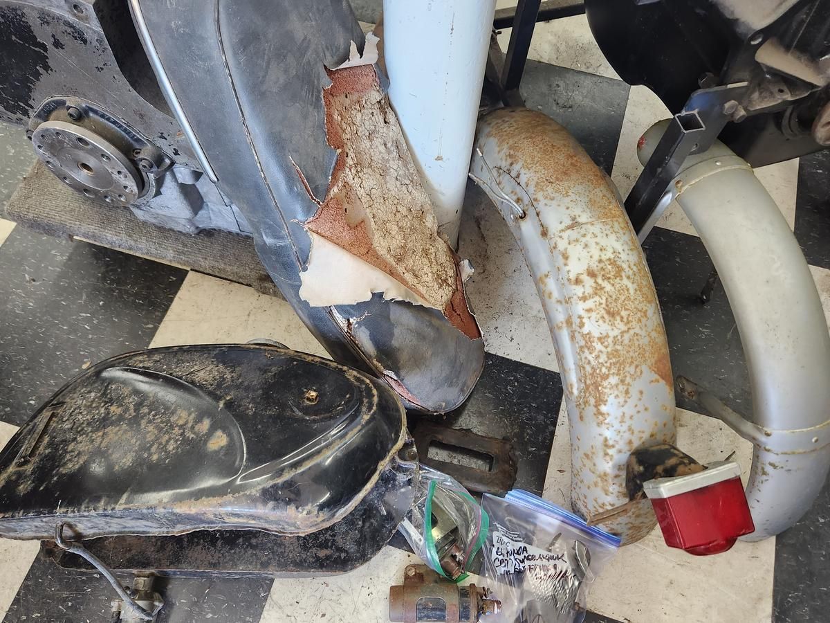 A close up of a motorcycle fender on a checkered floor