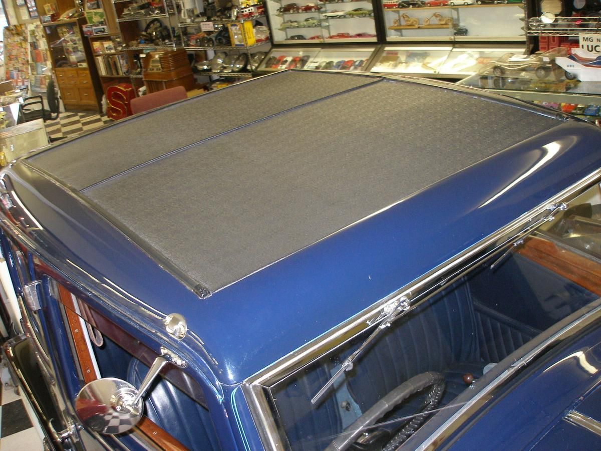 A blue car with a black roof is in a store