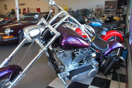 a purple harley davidson motorcycle is parked in a garage
