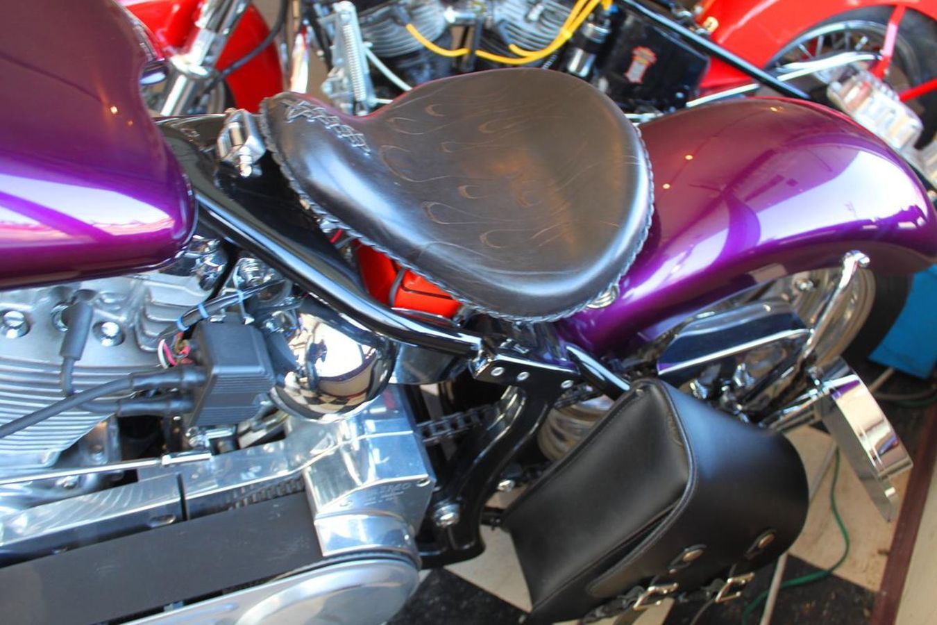 A close up of a purple motorcycle with a black seat