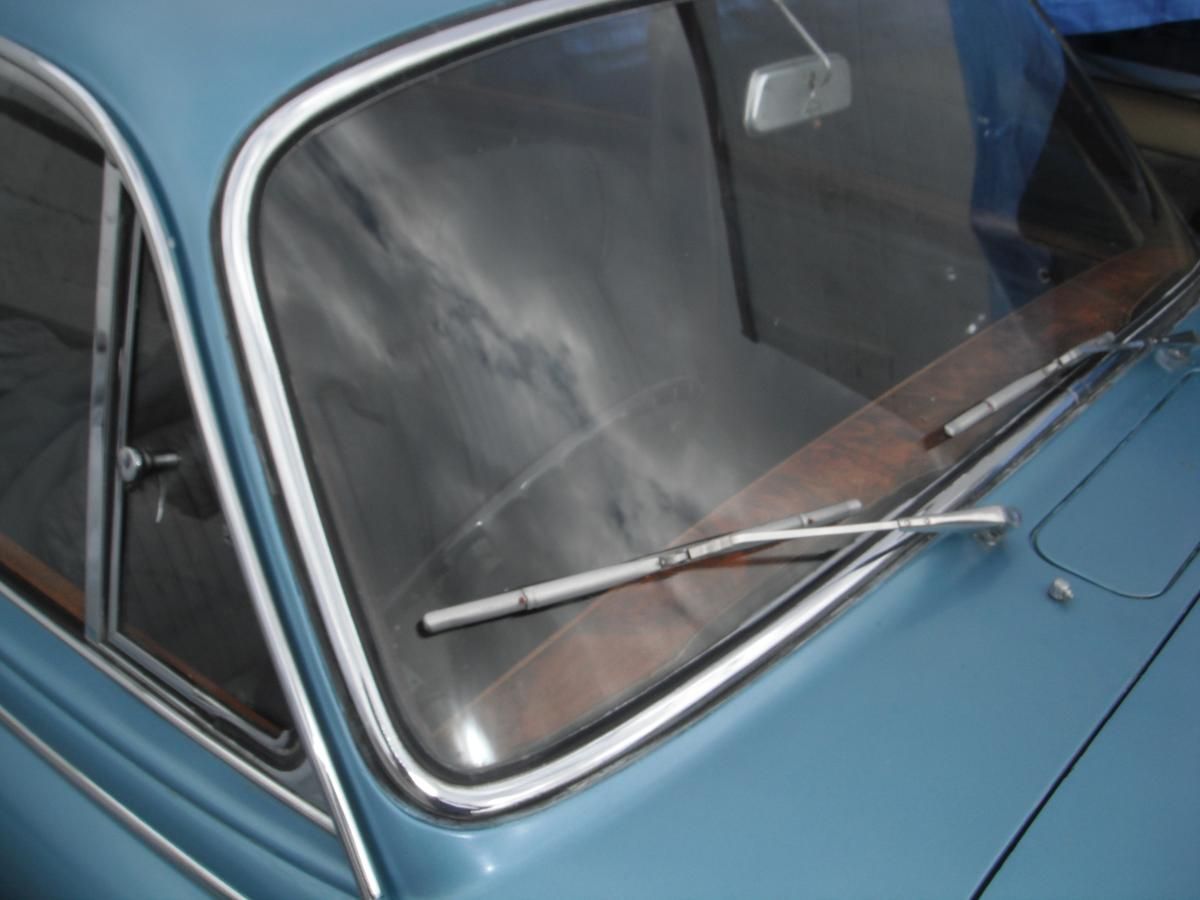 A close up of a car windshield with wiper blades