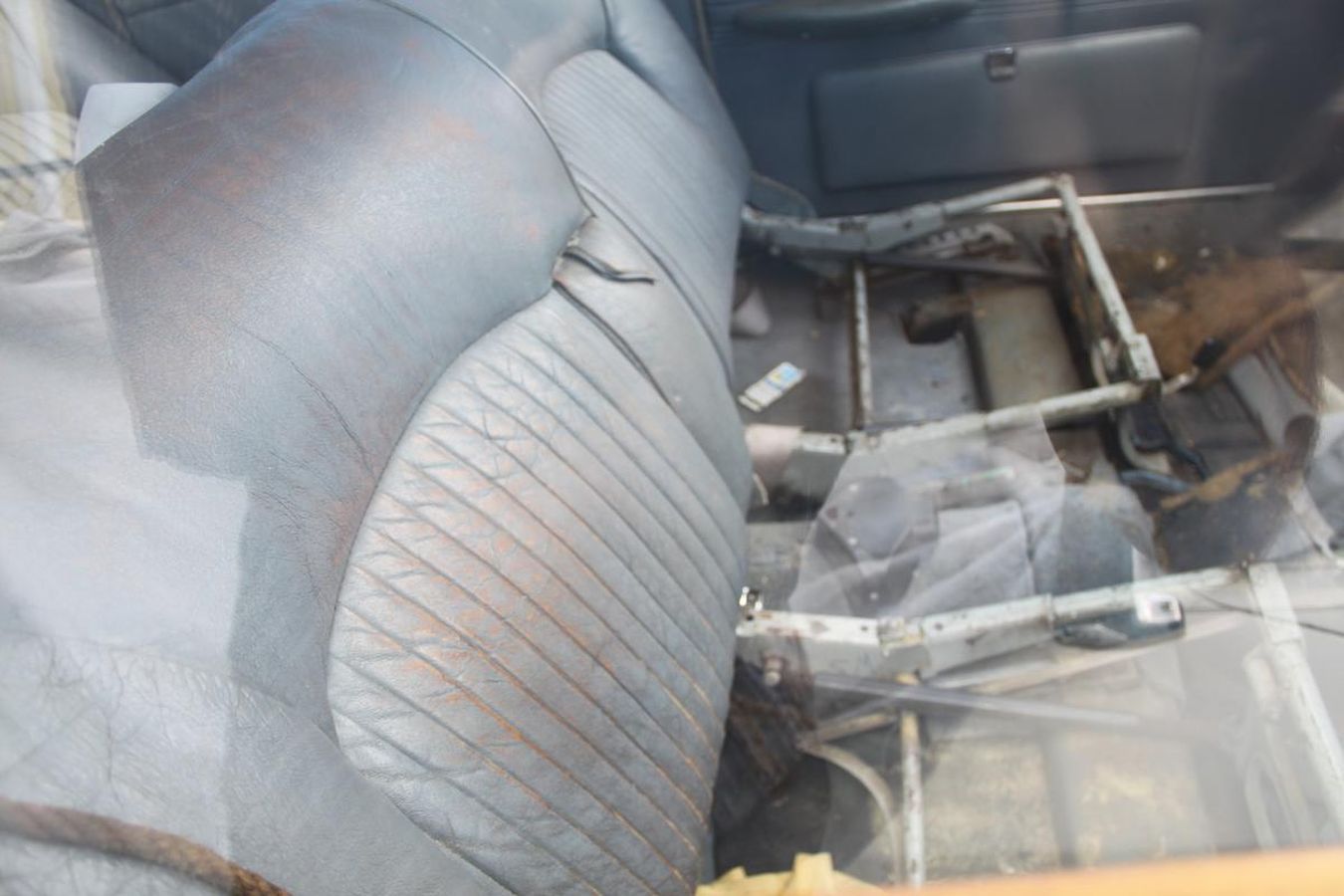 The back seat of a car with a clear plastic covering on it