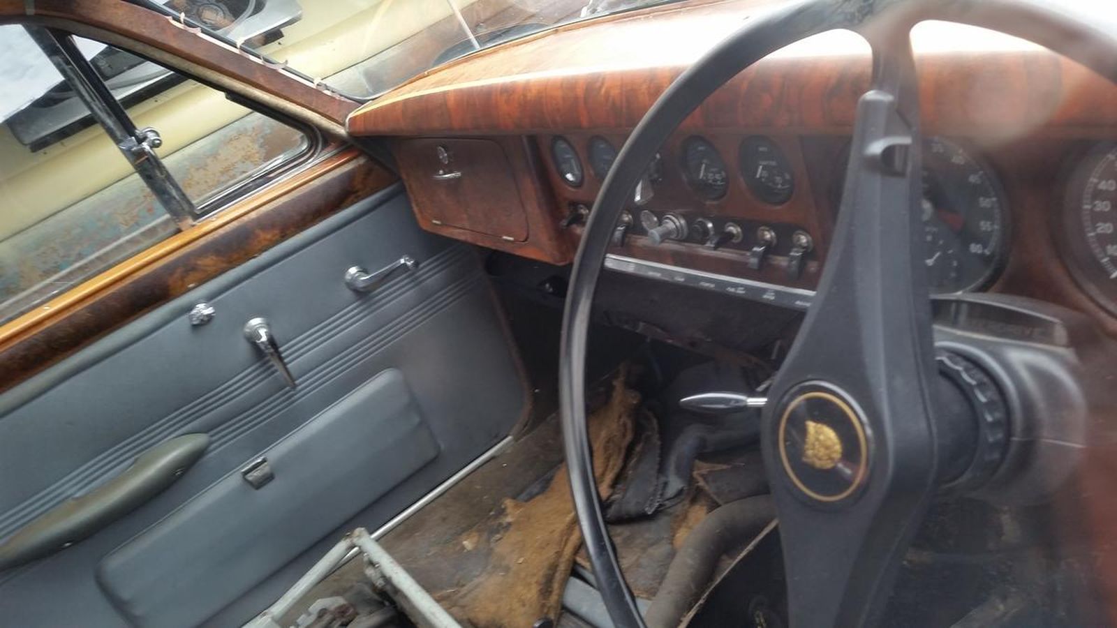 The inside of a car with a steering wheel and dashboard