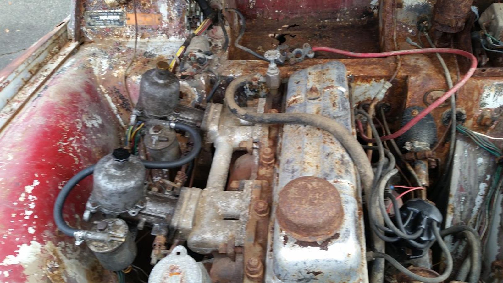 A close up of a rusty engine in a car.