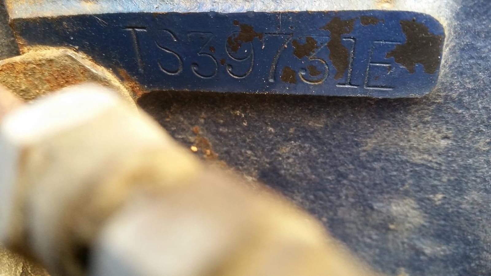 A close up of a piece of metal with a number on it.