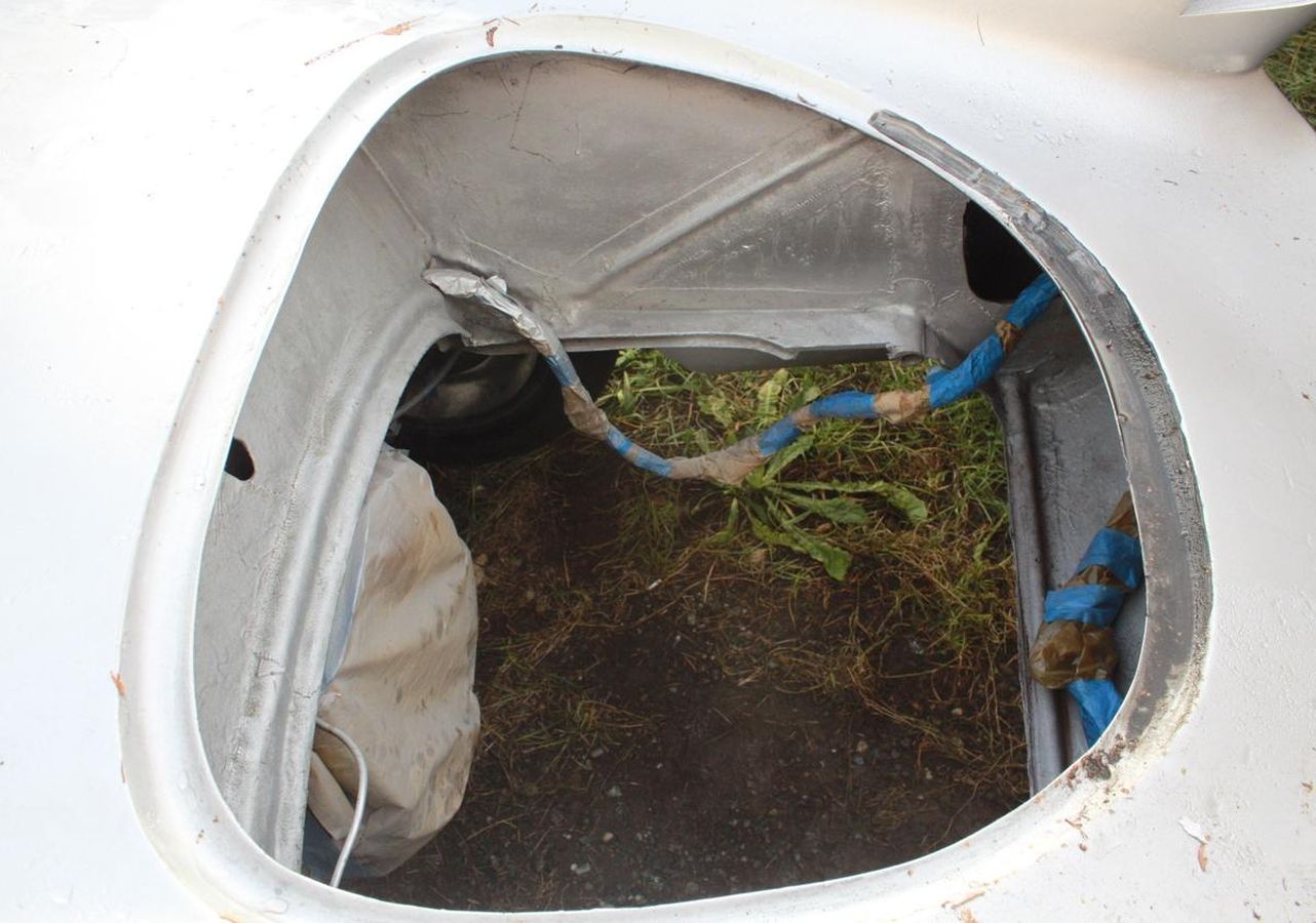 The inside of a white car with a hole in it