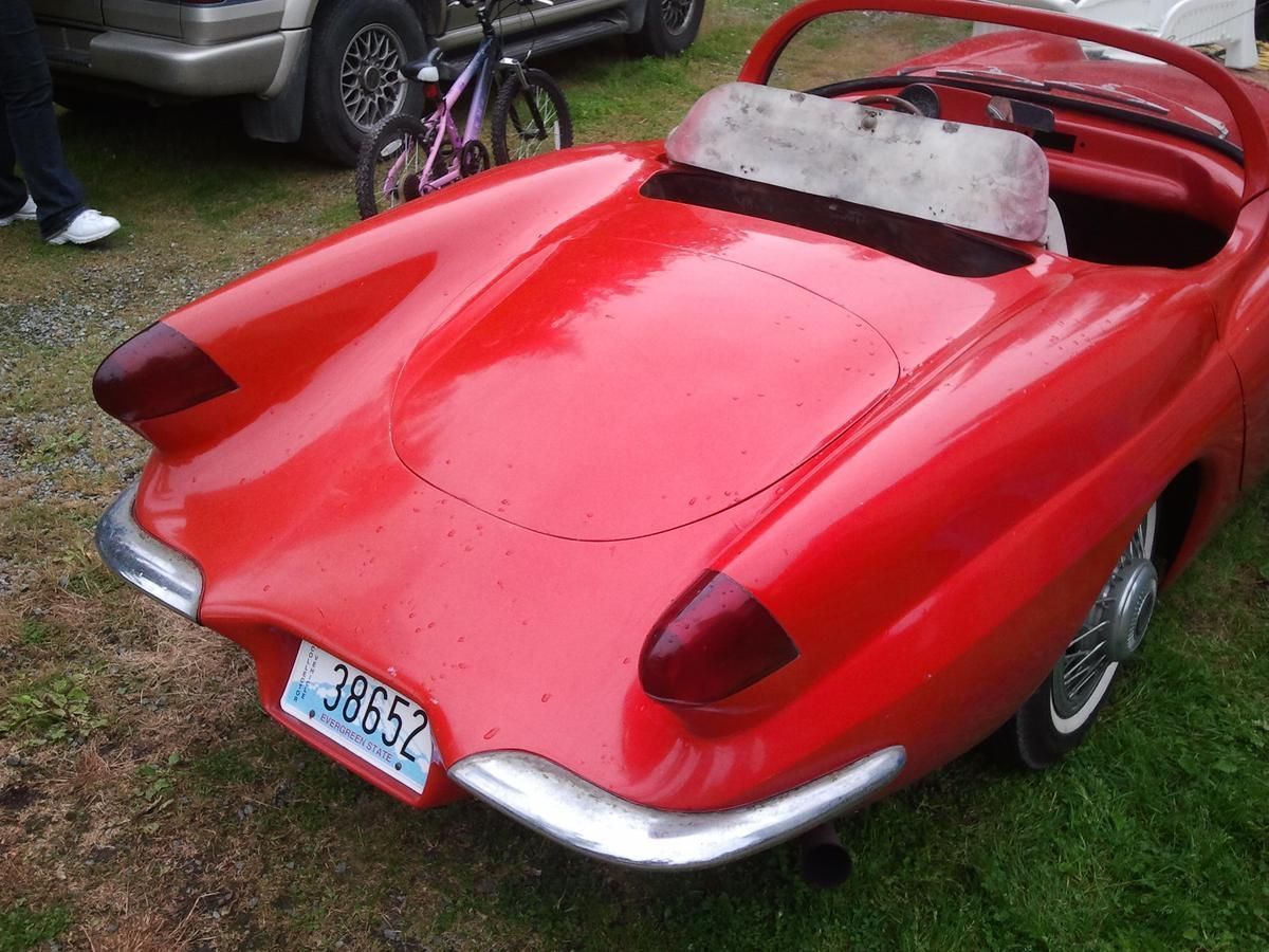 A red car has a license plate that says 36552