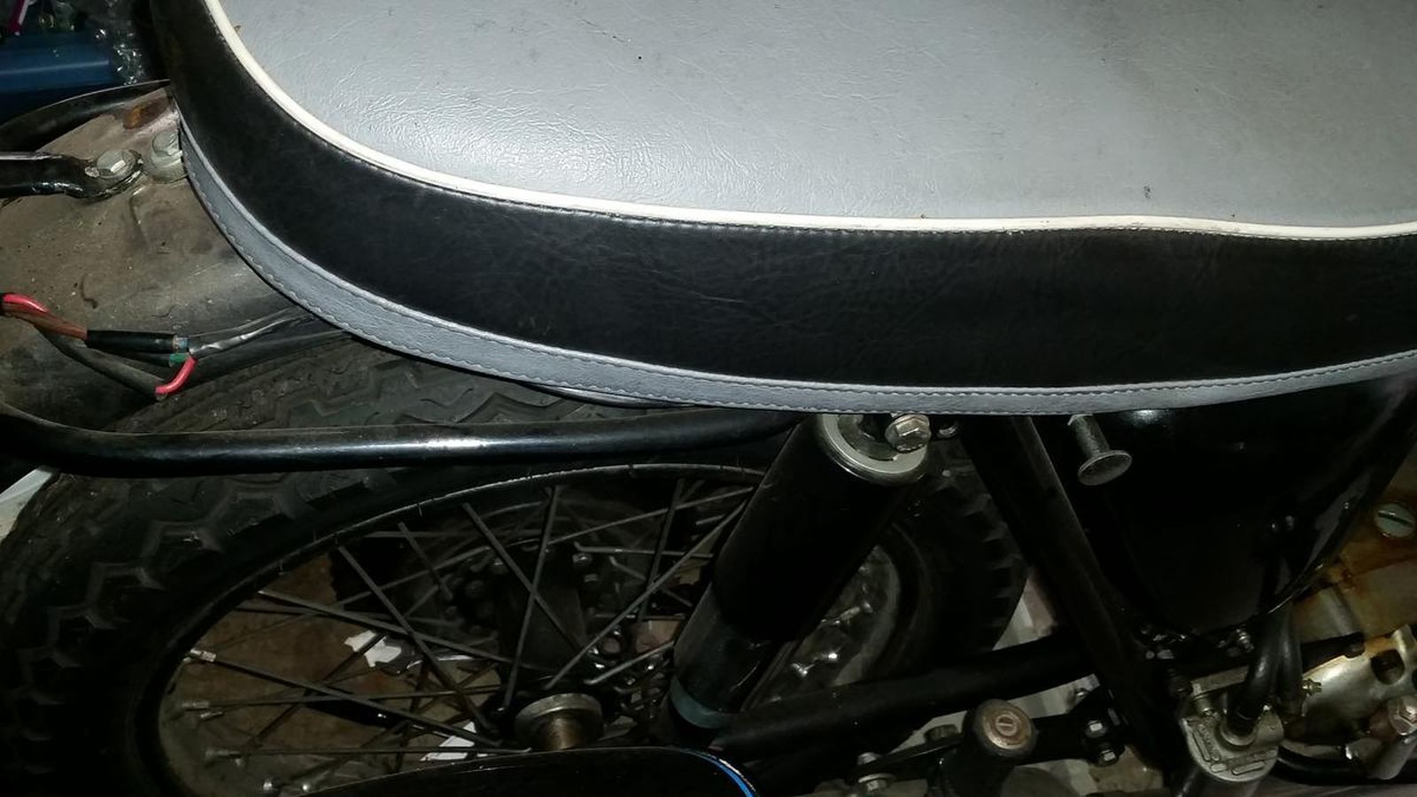 A close up of a motorcycle with a black seat