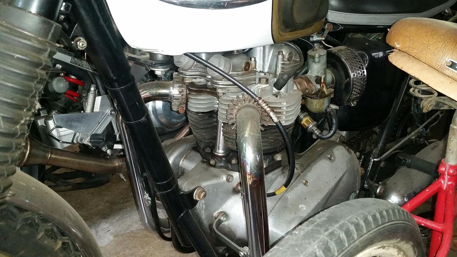 A close up of a motorcycle engine in a garage.