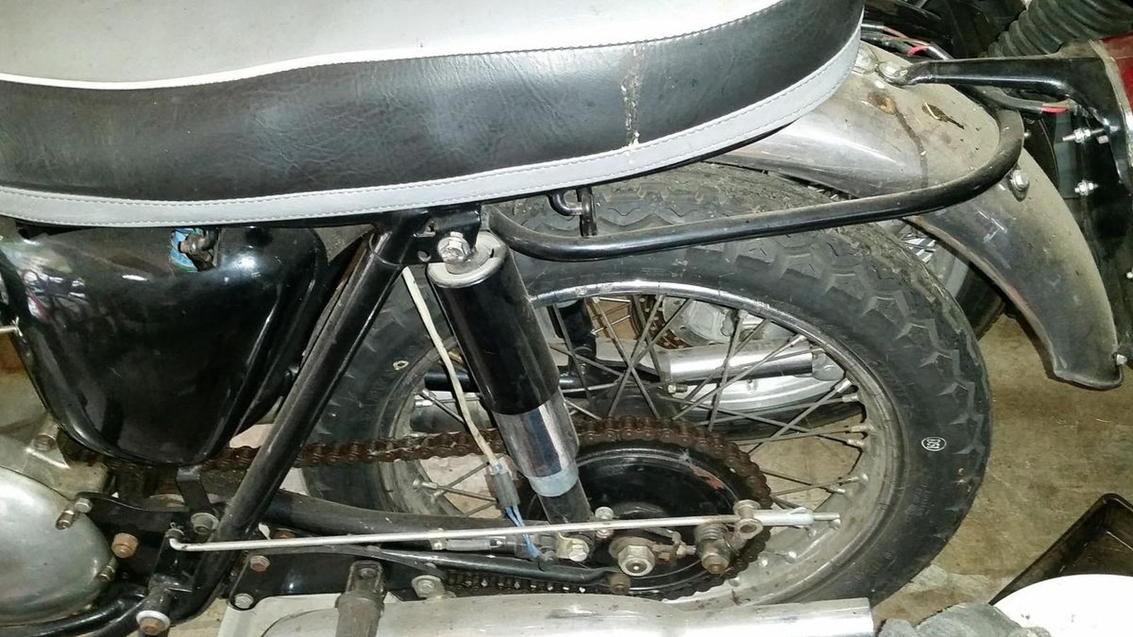 A close up of a motorcycle with a black seat and fender.