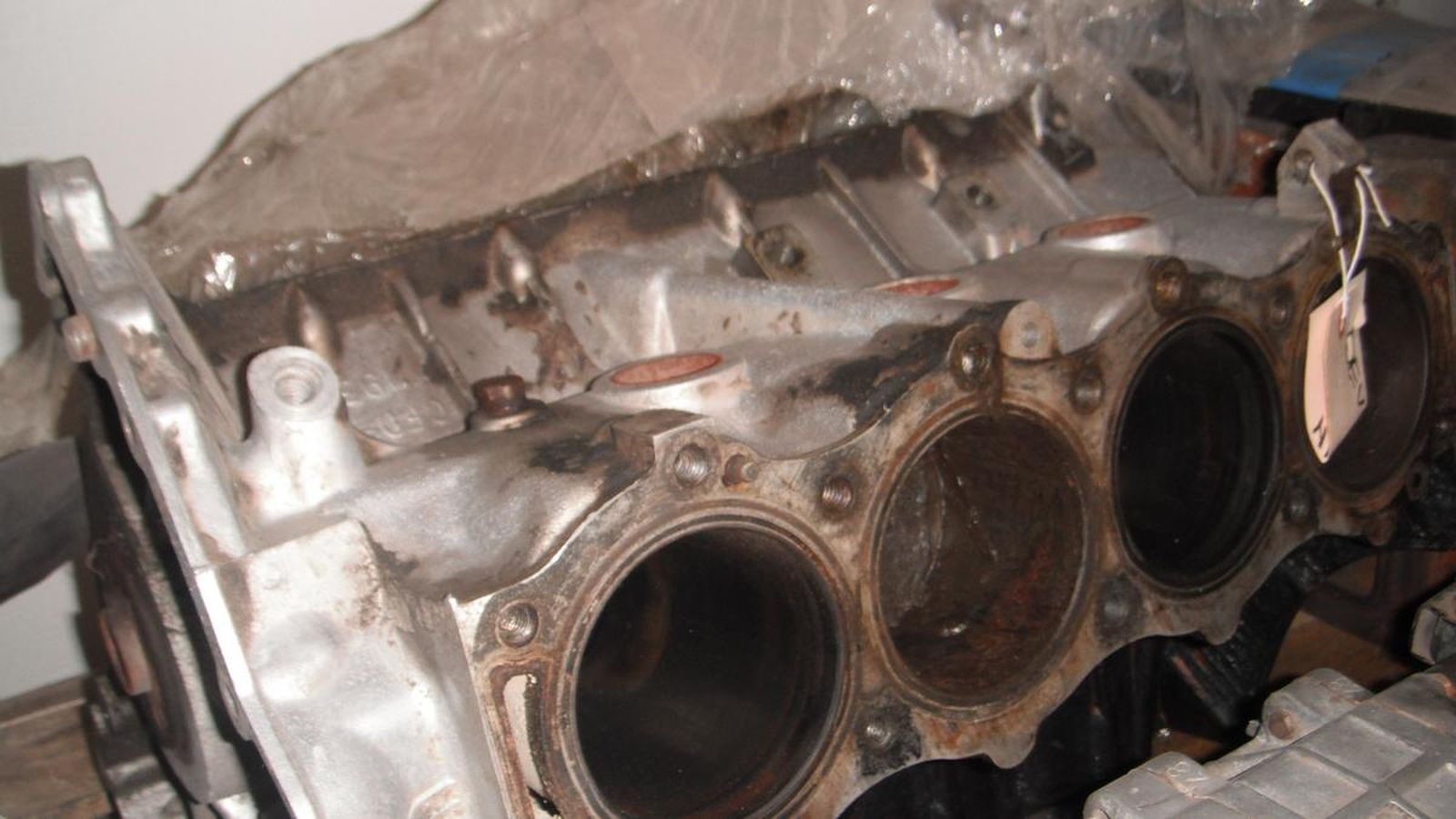 A close up of a cylinder block with a tag on it