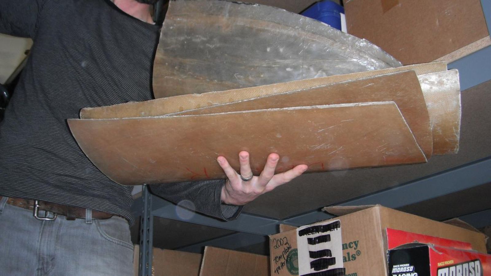 A man is holding a piece of cardboard in his hand