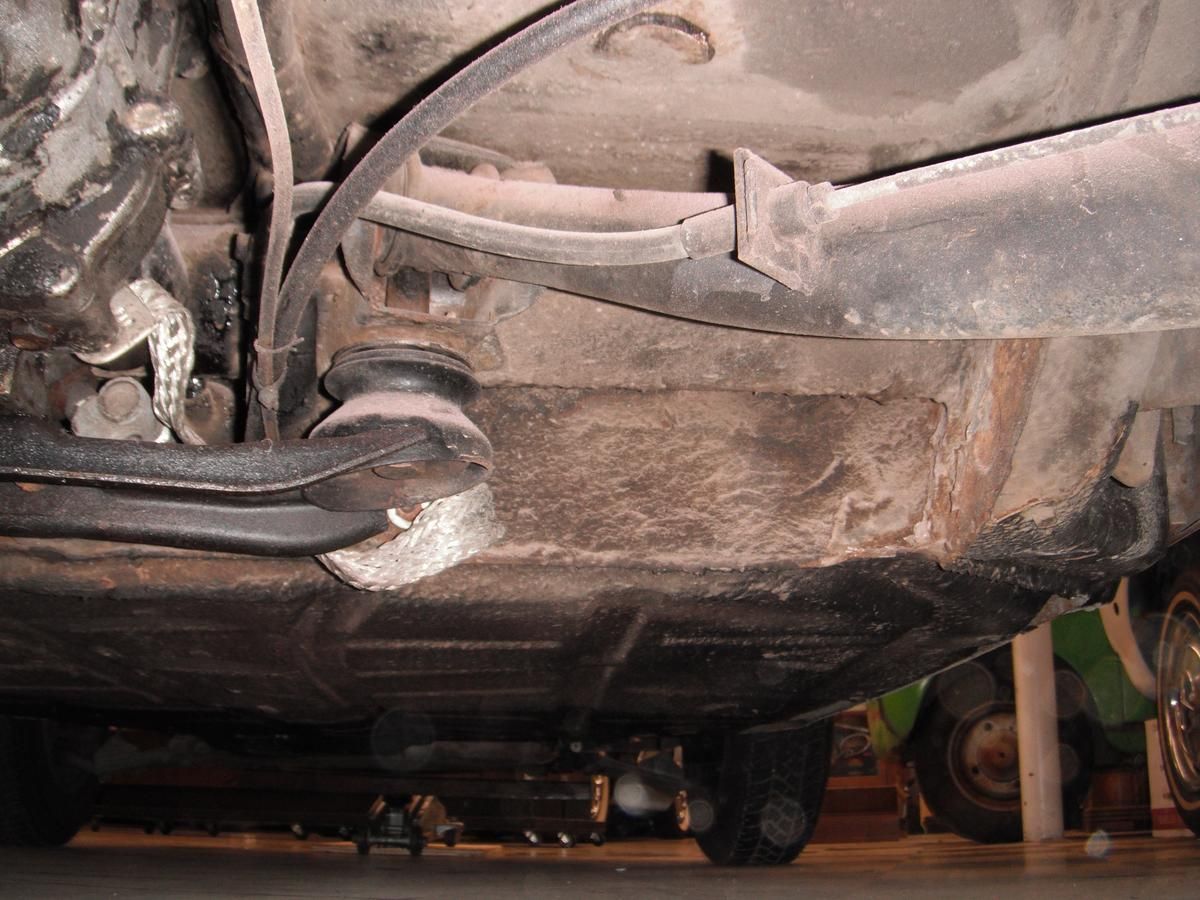 A close up of the underside of a car in a garage