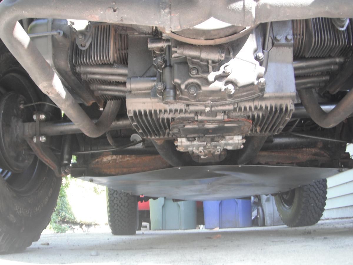 The underside of a car with the engine visible
