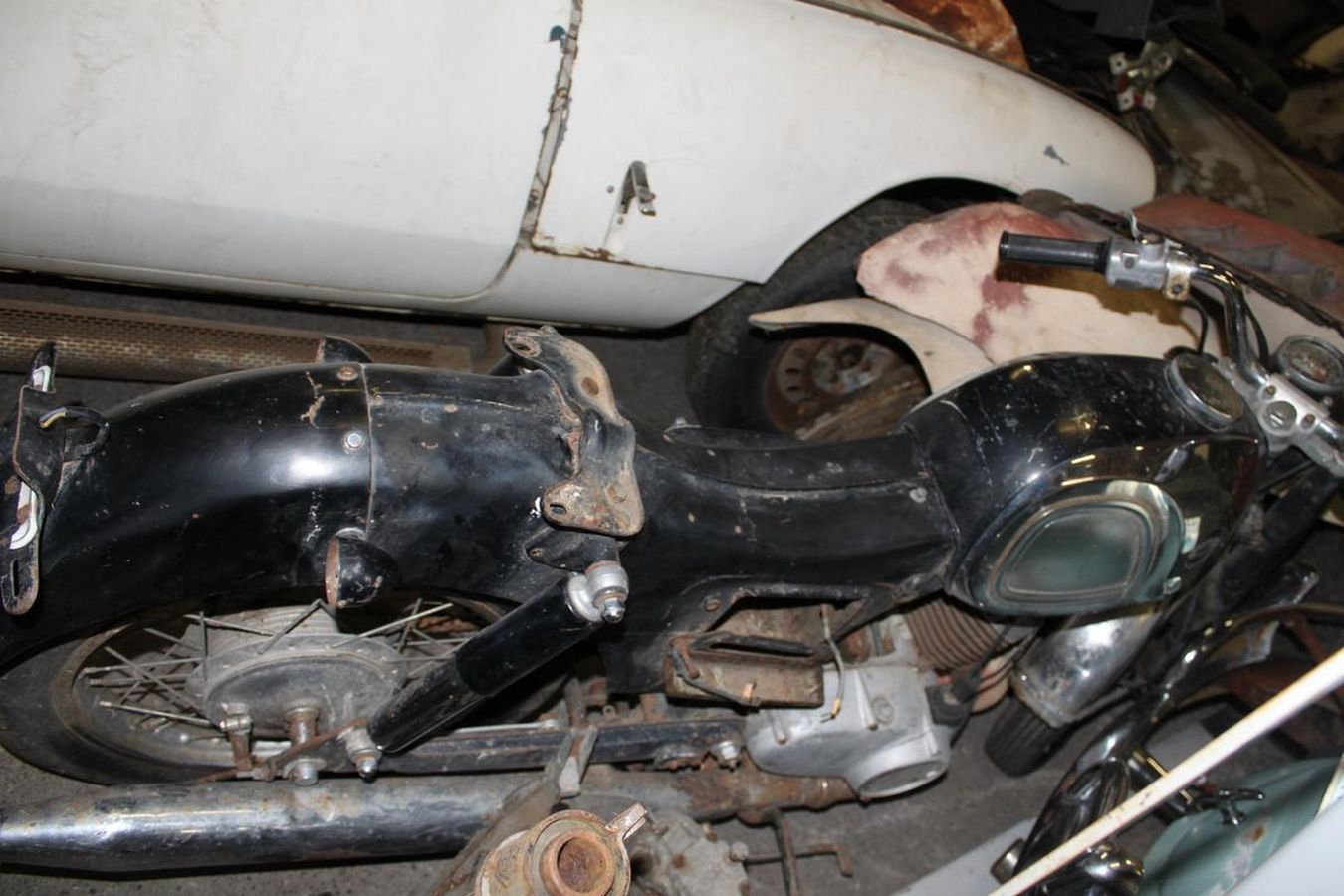A black and white motorcycle is sitting in a garage