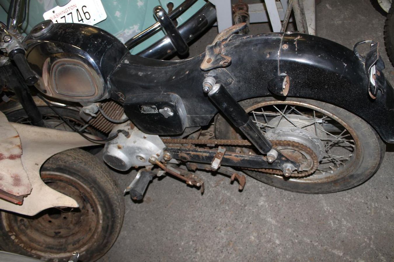 A black motorcycle with a tag that says r746 on it