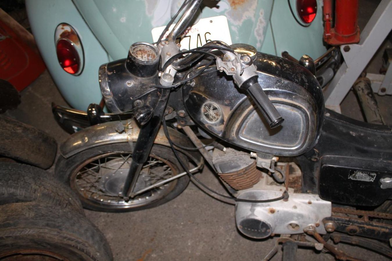 An old motorcycle with a license plate that says 7as