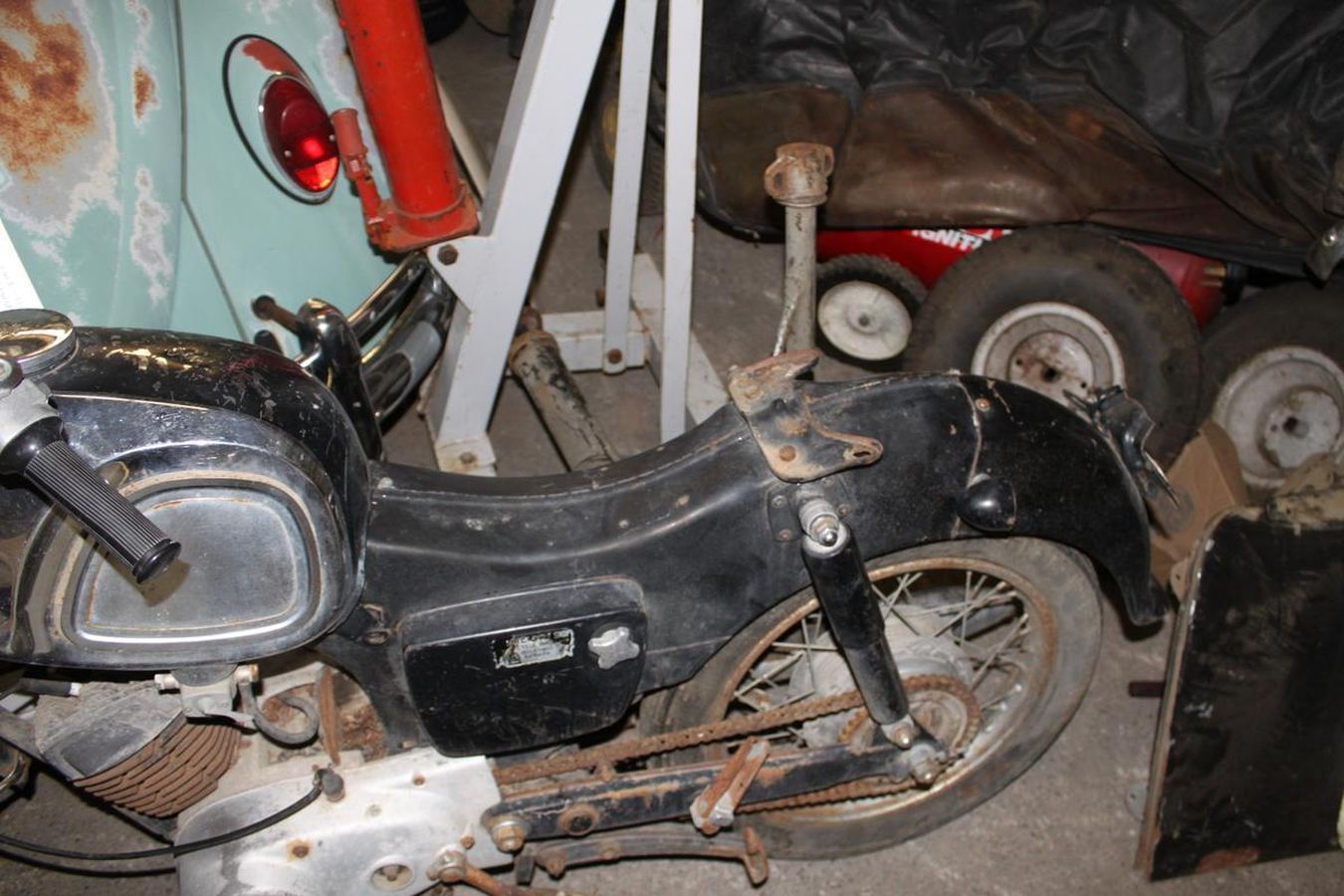 A black and silver motorcycle is sitting in a garage