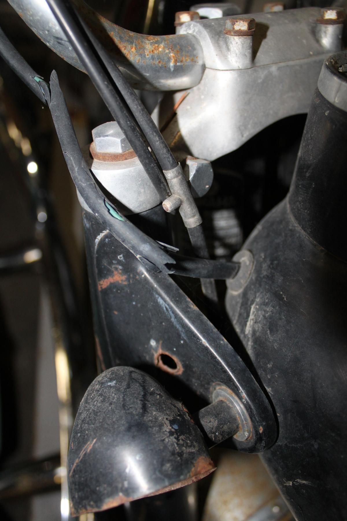 A close up of a motorcycle 's handlebars and headlight