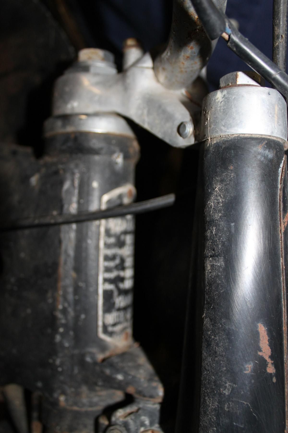 A close up of a fork on a motorcycle.