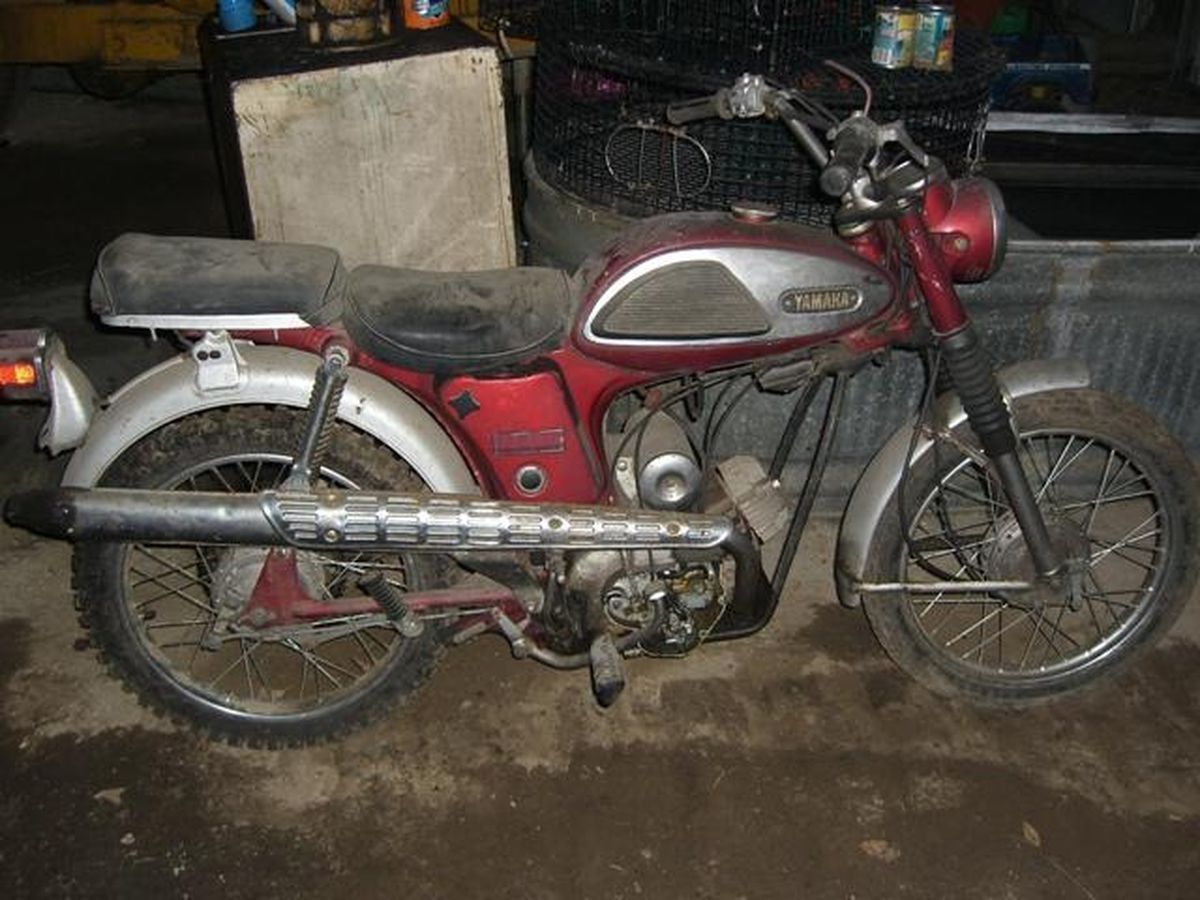 A red yamaha motorcycle is parked in a garage