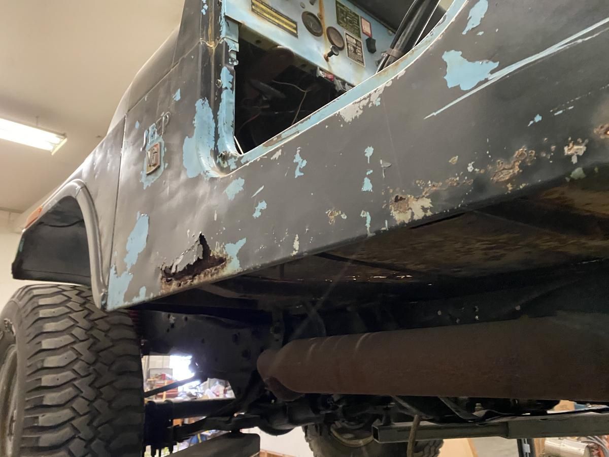 The underside of a jeep with the door open