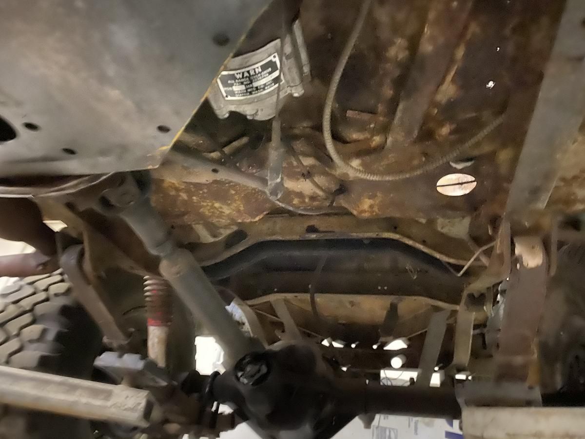 A close up of the underside of a rusty vehicle