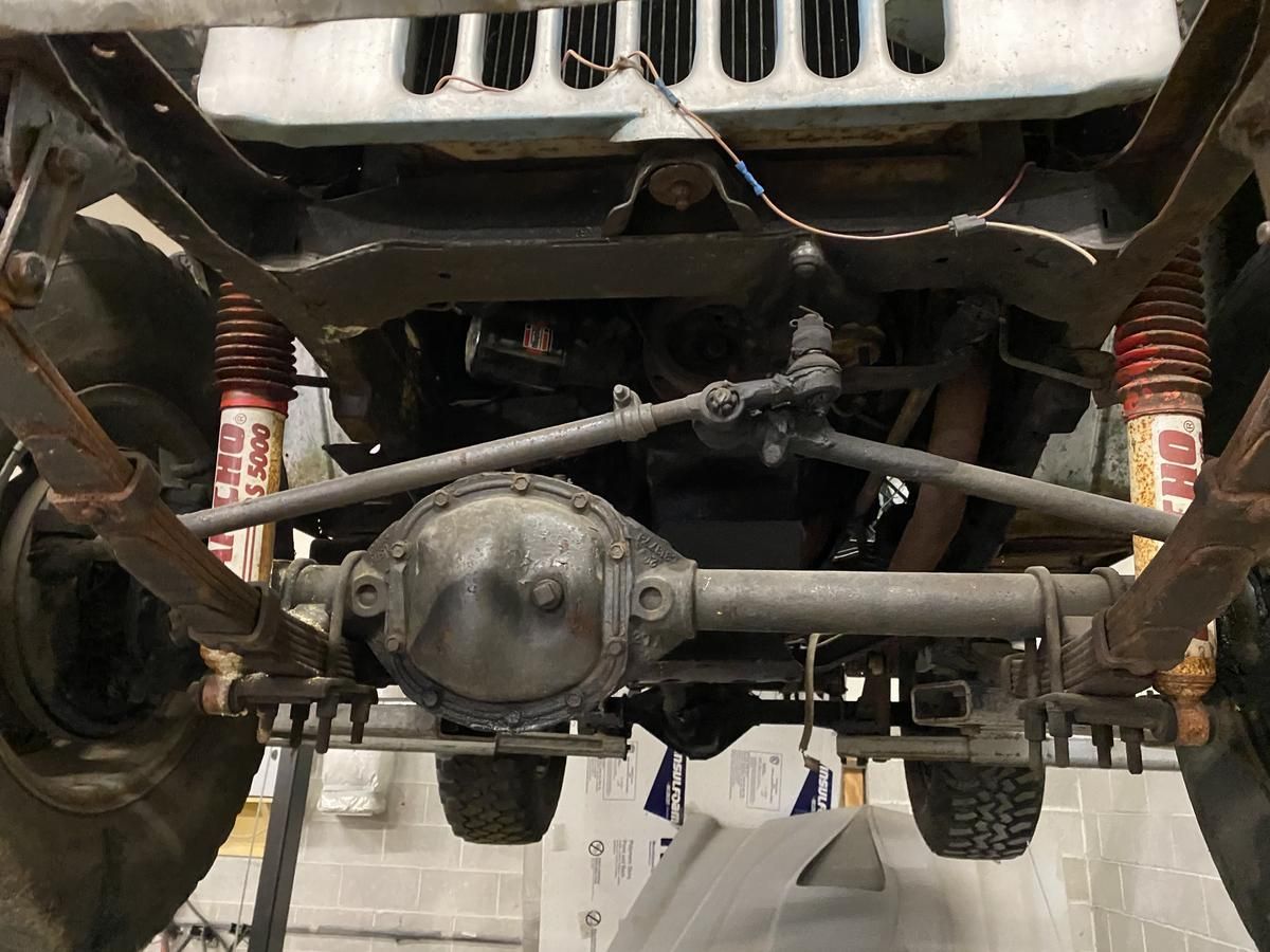 The underside of a jeep with shocks on it