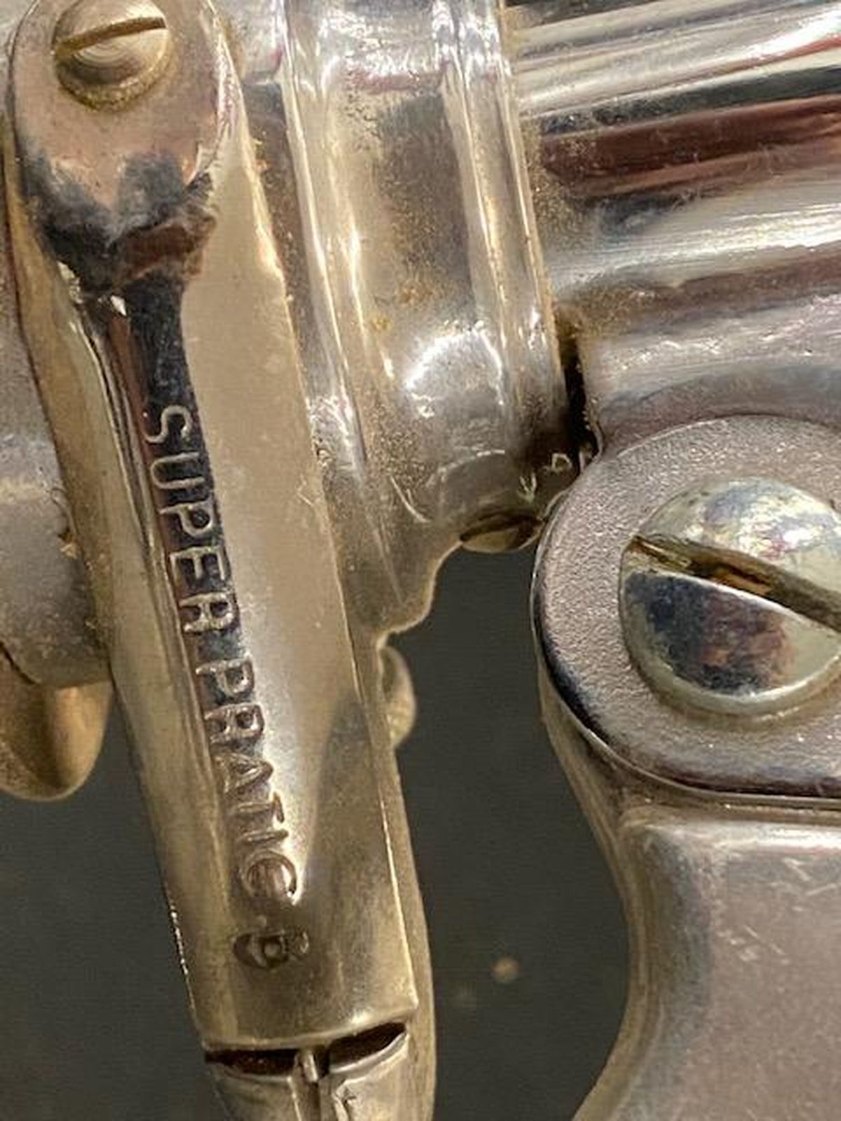 A close up of a silver revolver with the word super on it.