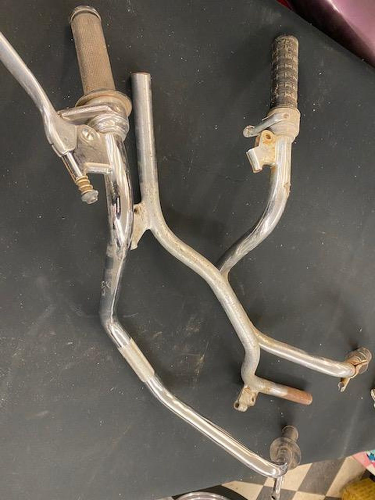 A pair of bicycle handlebars are sitting on a black table.