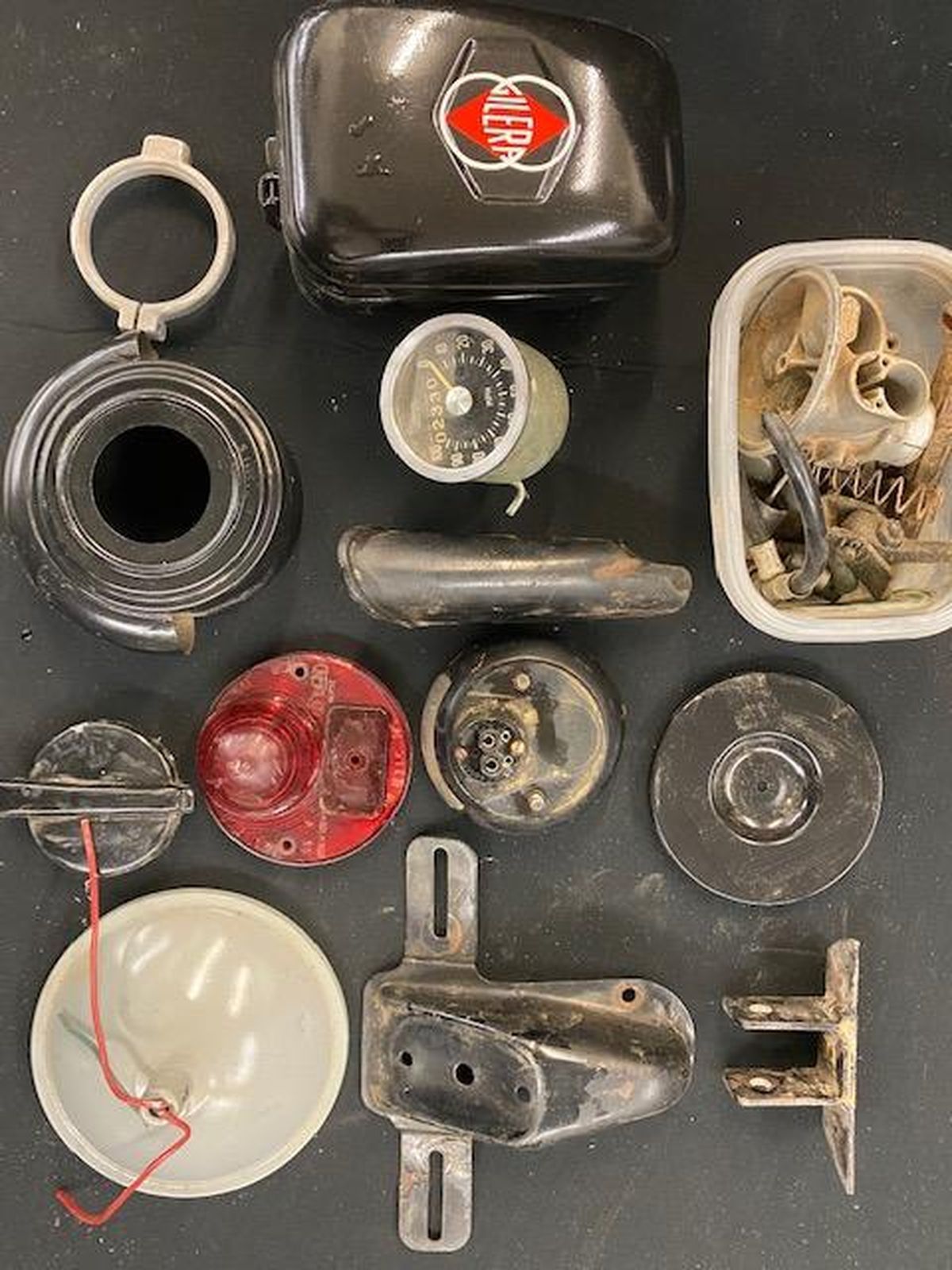 A bunch of old motorcycle parts are sitting on a table