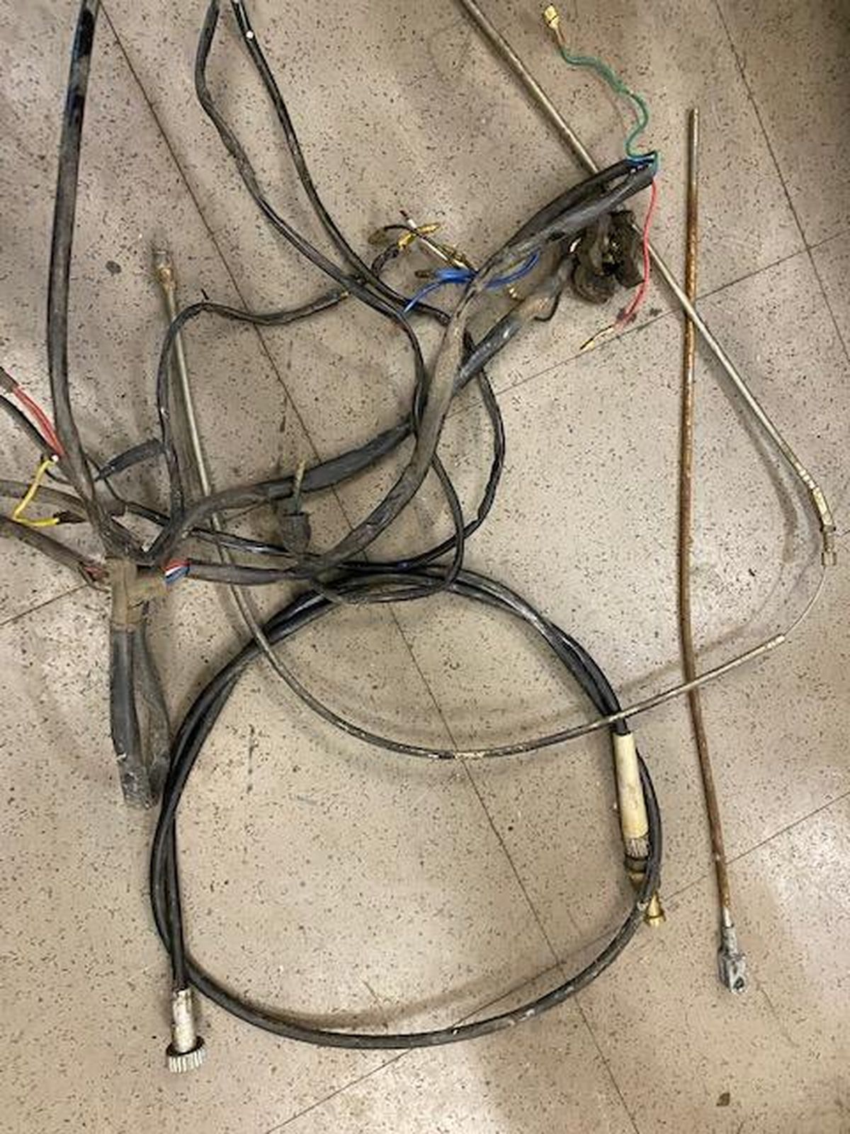 A bunch of wires are laying on the floor.