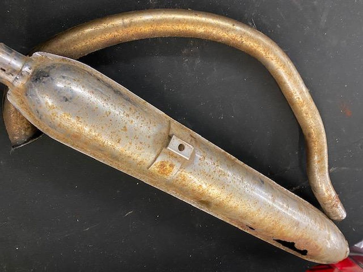 A close up of a metal object on a black surface